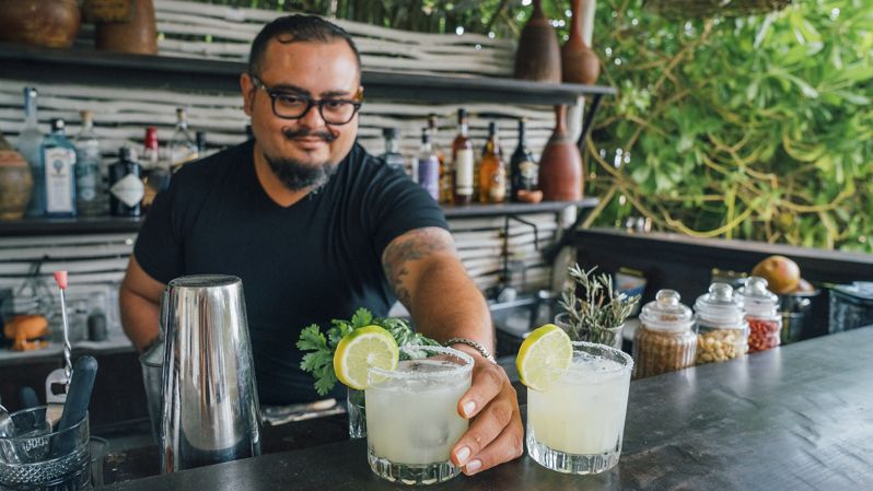NEST Tulum is a Boutique Hotel with gorgeous beach front views, hammocks, palms trees and coast, beach bed huts and sun beds in Tulum, Riviera Maya, Mexico.