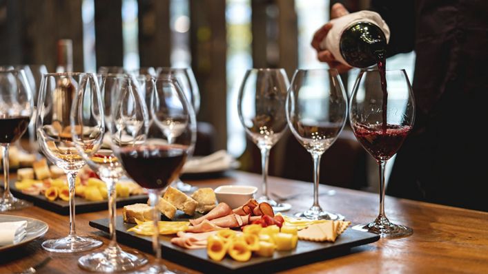 Close-up on a sommelier serving glasses of winetasting event